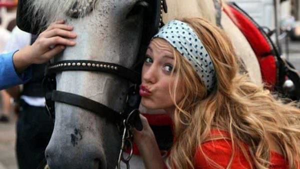 Blake Lively kisses a grey carriage horse